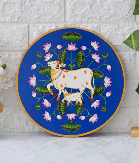 Pichwai Painting: This beautiful pichwai painting features a mother cow and her calf nuzzling each other, surrounded by a vibrant array of flowers